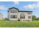 Lovely home exterior with a large backyard, lush lawn, and a comfortable patio seating arrangement at 2485 Alexandra Dr, Carmel, IN 46074