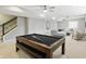 Finished basement features a pool table, sitting area, and modern staircase at 2485 Alexandra Dr, Carmel, IN 46074