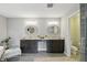 Elegant bathroom featuring dual vanities, granite countertops, decorative mirrors, and a separate shower area at 2485 Alexandra Dr, Carmel, IN 46074