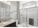 Modern bathroom featuring a granite vanity, framed mirror, and glass-enclosed shower with tiled walls at 2485 Alexandra Dr, Carmel, IN 46074