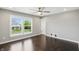 Bright bedroom with hardwood floors, a ceiling fan, and a window view of the neighborhood at 2485 Alexandra Dr, Carmel, IN 46074