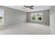 Spacious bedroom with neutral carpet, a ceiling fan, and a window view of the outdoors at 2485 Alexandra Dr, Carmel, IN 46074