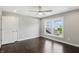 Empty bedroom with hardwood floors, a ceiling fan, and a window view of the outdoors at 2485 Alexandra Dr, Carmel, IN 46074