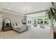 Bright main bedroom with a neutral color palette, carpet, large windows, and sitting area with cozy chairs at 2485 Alexandra Dr, Carmel, IN 46074