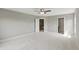 Spacious bedroom with neutral paint, ceiling fan and carpet, featuring entrances to a closet and bathroom at 2485 Alexandra Dr, Carmel, IN 46074