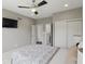 Clean bedroom featuring closet space, a ceiling fan, and a wall-mounted TV for convenient entertainment at 2485 Alexandra Dr, Carmel, IN 46074