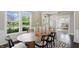 Bright dining room featuring wood table, stylish chairs, and large windows with neighborhood views at 2485 Alexandra Dr, Carmel, IN 46074