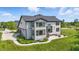 Stunning two-story home featuring neutral siding, large windows, a patio, and professional landscaping at 2485 Alexandra Dr, Carmel, IN 46074