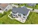 Aerial view of a home, highlighting its neutral siding, dark roof, patio, and well-maintained lawn at 2485 Alexandra Dr, Carmel, IN 46074