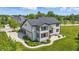 Rear aerial view showing an elegant home with patio, well-maintained lawn, and three-car garage at 2485 Alexandra Dr, Carmel, IN 46074