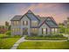 Beautiful two-story home featuring a well-manicured lawn and a combination of brick and siding at 2485 Alexandra Dr, Carmel, IN 46074