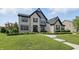 Attractive two-story home with brick and blue siding and well-manicured lawn at 2485 Alexandra Dr, Carmel, IN 46074