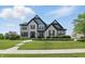 Stunning two-story home featuring beautiful brickwork, lush landscaping, and a well-maintained front lawn at 2485 Alexandra Dr, Carmel, IN 46074