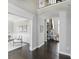 Hallway showcasing wood floors, leading to a living room with fireplace at 2485 Alexandra Dr, Carmel, IN 46074