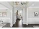Hallway featuring dark wood floors and archway views into other living spaces at 2485 Alexandra Dr, Carmel, IN 46074