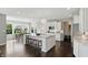 Bright kitchen features a large center island, stainless appliances, dark wood floors, and a window overlooking the front yard at 2485 Alexandra Dr, Carmel, IN 46074