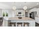 Kitchen island with seating and granite countertops, pendant lighting, stainless appliances, and white cabinets at 2485 Alexandra Dr, Carmel, IN 46074