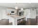 Bright kitchen features a large center island, stainless appliances, dark wood floors, and white cabinets at 2485 Alexandra Dr, Carmel, IN 46074
