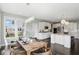 Spacious, open kitchen with white cabinetry, stainless steel appliances, an island, and an adjacent dining area at 2485 Alexandra Dr, Carmel, IN 46074