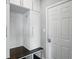 Well-organized mudroom with white cabinets, hooks, a bench, and cubbies for storage and functionality at 2485 Alexandra Dr, Carmel, IN 46074