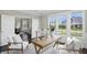 Well-lit home office with wooden desk, accent chair, and bright windows overlooking a residential street at 2485 Alexandra Dr, Carmel, IN 46074
