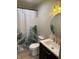 Bathroom featuring a green and white patterned shower curtain, round mirror and modern sink at 258 Riverwood Dr, Noblesville, IN 46062