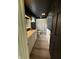 Modern bathroom with double sink vanity, dark walls and wood look tile floors at 258 Riverwood Dr, Noblesville, IN 46062