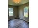 Bedroom featuring neutral paint, white trim, gray floors, and a stylish light fixture at 258 Riverwood Dr, Noblesville, IN 46062