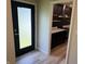 Inviting entryway with a black front door and bright kitchen view through the door frame at 258 Riverwood Dr, Noblesville, IN 46062
