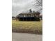 Charming home with a black foundation, wooden deck, and a spacious yard at 258 Riverwood Dr, Noblesville, IN 46062