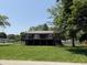 Two-story home featuring a black support beam design, second story balcony, and a spacious lawn at 258 Riverwood Dr, Noblesville, IN 46062