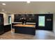 Modern kitchen with butcher block island, stainless hood, floating shelves and black cabinets at 258 Riverwood Dr, Noblesville, IN 46062