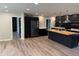 Open-concept kitchen showcasing dark cabinetry, stainless steel appliances, and hardwood floors, great for gatherings at 258 Riverwood Dr, Noblesville, IN 46062