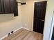 Functional laundry area with dark cabinets and a black door, offering both style and convenience at 258 Riverwood Dr, Noblesville, IN 46062
