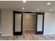 Living room with large, glass sliding barn doors to another room at 258 Riverwood Dr, Noblesville, IN 46062