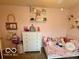 This charming bedroom features a single bed and soft pastel decor at 2637 Grand Fir Dr, Greenwood, IN 46143