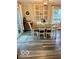 Bright dining area featuring wood-look floors, a table for six, and curated wall decor at 2637 Grand Fir Dr, Greenwood, IN 46143