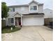 Two-story home with neutral siding, a red front door, and an attached two-car garage at 2637 Grand Fir Dr, Greenwood, IN 46143