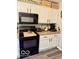 Functional kitchen with white cabinets, black appliances, and plenty of storage space at 2637 Grand Fir Dr, Greenwood, IN 46143