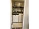 Efficient laundry room features a front-load washer and dryer, shelving, and decorative accents at 2637 Grand Fir Dr, Greenwood, IN 46143