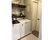 Cozy laundry area features a front-load washer and dryer with shelving and decor above appliances at 2637 Grand Fir Dr, Greenwood, IN 46143