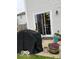View of the outdoor patio with sliding door access, a covered grill, and various potted plants at 2637 Grand Fir Dr, Greenwood, IN 46143