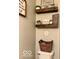 The small powder room with shelving and wood accents presents a functional design at 2637 Grand Fir Dr, Greenwood, IN 46143