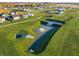 Aerial view of the pond and playground area in a neighborhood with attractive landscaping at 284 N Bur Oak Dr, Mooresville, IN 46158
