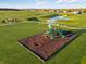 Aerial view of the community playground area and walking path near the pond at 284 N Bur Oak Dr, Mooresville, IN 46158