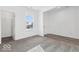 Bright bedroom with carpet flooring and natural light, featuring a walk in closet and adjacent entry door at 284 N Bur Oak Dr, Mooresville, IN 46158