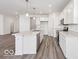 Modern kitchen features white cabinetry, stainless steel appliances, granite countertops, and pendant lighting at 284 N Bur Oak Dr, Mooresville, IN 46158