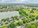 Expansive aerial view of a lakeside community, showcasing waterfront homes, lush landscapes, and city skyline at 2841 Tropical Dr, Indianapolis, IN 46205