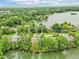 Scenic aerial view showcasing homes nestled amongst the lush green landscape by the lakeside at 2841 Tropical Dr, Indianapolis, IN 46205