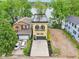 Breathtaking aerial view of a charming lakeside home with manicured lawn and a private driveway at 2841 Tropical Dr, Indianapolis, IN 46205